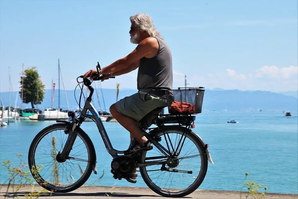 Easy E-Biking - man e-cycling along sea, helping to make electric biking practical and fun